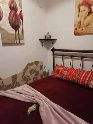 a bedroom with a bed with red pillows on it at Bersimi Lazaridis in Rhodes Town