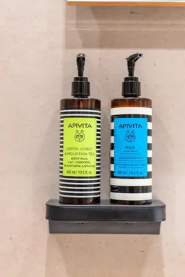 two bottles of antiochentshaped on a shelf at Stylish Suite in Rhodes Town