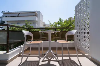 a balcony with a table and two chairs at Stylish Suite in Rhodes Town