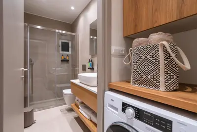 a laundry room with a washer and dryer in a bathroom at Stylish Suite in Rhodes Town