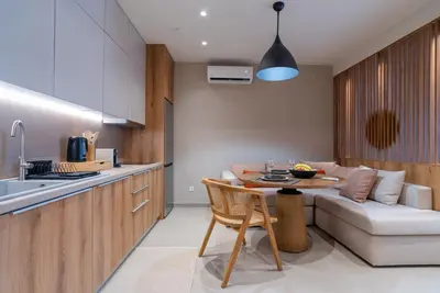 a kitchen and living room with a table and a couch at Stylish Suite in Rhodes Town