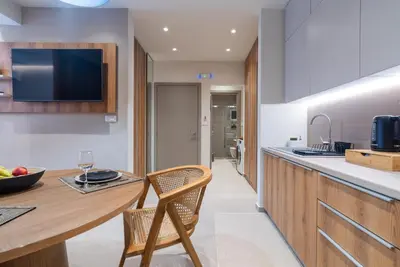 a kitchen with a wooden counter and a table and chairs at Stylish Suite in Rhodes Town