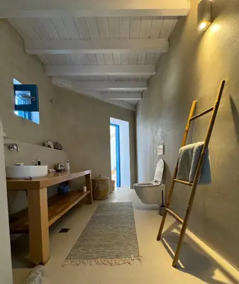 a bathroom with a sink and a toilet at Kertenia - Villa Vayu in Kattavía