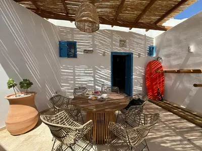 a patio with a table and chairs on a patio at Kertenia - Villa Vayu in Kattavía