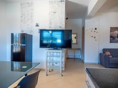 a living room with a flat screen tv on a table at Village View Afandou in Afantou