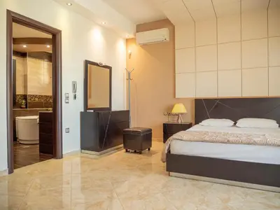 a bedroom with a bed and a bathroom at Village View Afandou in Afantou