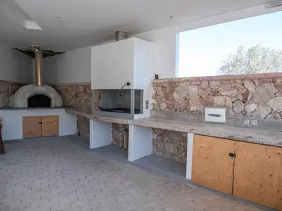 a kitchen with a counter and a stone wall at Village View Afandou in Afantou