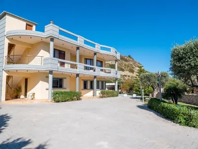 a large white building with a driveway at Village View Afandou in Afantou