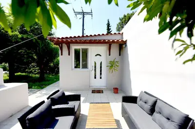 a white patio with couches and a white door at Liri family paradise Danis house in Ixia