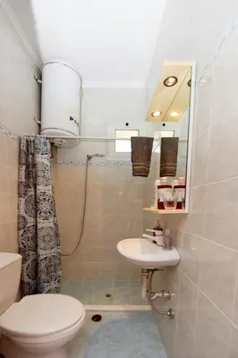 a bathroom with a toilet and a sink at Liri family paradise Danis house in Ixia
