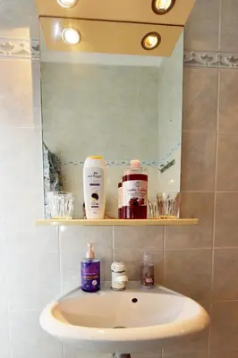 a bathroom sink with a mirror above it at Liri family paradise Danis house in Ixia
