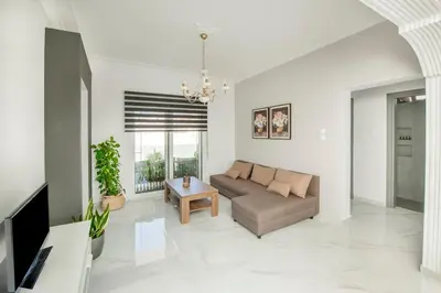 a living room with a couch and a table at Sokrates Residence in Afantou