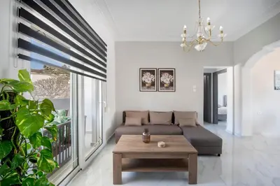 a living room with a couch and a table at Sokrates Residence in Afantou