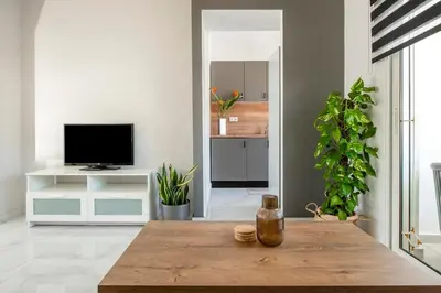 a living room with a table and a tv at Sokrates Residence in Afantou