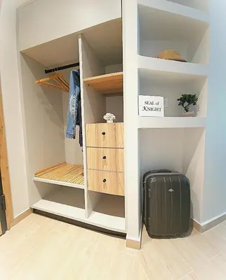 a room with a closet with a suitcase at SEAL of Knight - Castle View - Downtown near the Beach in Rhodes Town