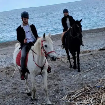 two people riding on horses on the beach at SEAL of Knight - Castle View - Downtown near the Beach in Rhodes Town