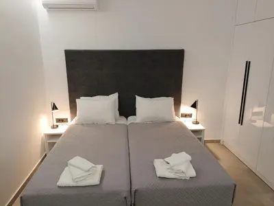 a bedroom with a large bed with two white pillows at Azure Mirage Home Adults Only Private Seaside Villa w Garden and Parking in Faliraki