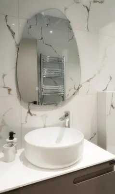 a bathroom with a white sink and a mirror at Azure Mirage Home Adults Only Private Seaside Villa w Garden and Parking in Faliraki