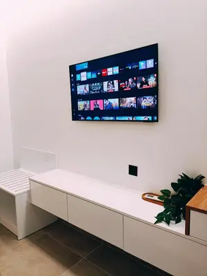 a flat screen tv hanging on a white wall at Azure Mirage Home Adults Only Private Seaside Villa w Garden and Parking in Faliraki