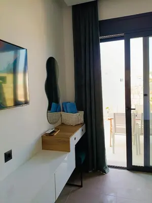 a room with a desk with blue pillows and a window at Azure Mirage Home Adults Only Private Seaside Villa w Garden and Parking in Faliraki
