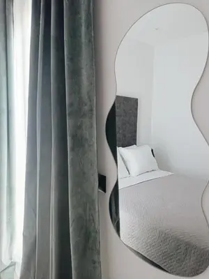a bedroom with a mirror next to a bed at Azure Mirage Home Adults Only Private Seaside Villa w Garden and Parking in Faliraki