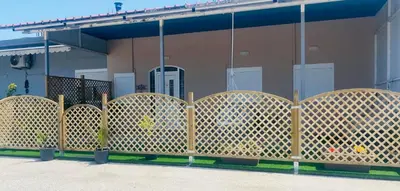 a wooden fence in front of a house at MariAggela's Cosy House in Theologos
