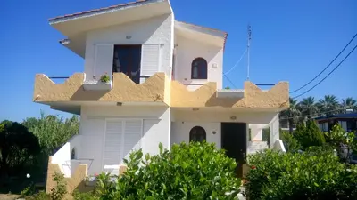 a white house with a spanish villa at Sunset Beach Studio in Kremasti