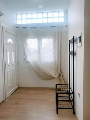 a room with a window with a curtain at MariAggela's Little House in Theologos
