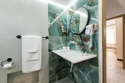 a bathroom with a sink and a mirror at Villa Perla in Lardos
