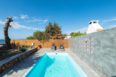 a swimming pool in the backyard of a house at Villa Perla in Lardos