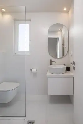 a white bathroom with a sink and a mirror at Villa Petalutha Rhodes in Kolimbia