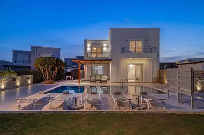 a villa with a swimming pool in front of a house at Villa Petalutha Rhodes in Kolimbia