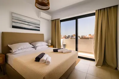 a bedroom with a bed with towels on it at Aquarama Pool Apt - Orion in Ixia