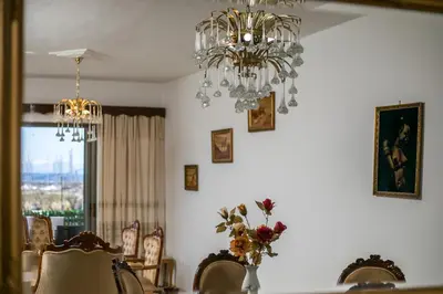 a dining room with a chandelier and a table with chairs at Rhodes Marina Apartment in Rhodes Town