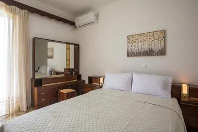a bedroom with a bed and a large mirror at Rhodes Marina Apartment in Rhodes Town