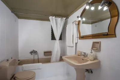 a bathroom with a sink and a toilet and a mirror at Rhodes Marina Apartment in Rhodes Town