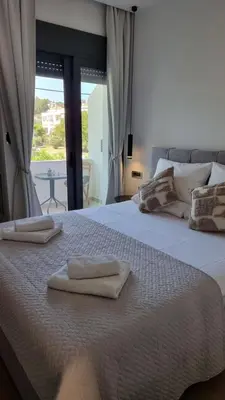 a bedroom with a bed with two towels on it at Sulaj Apartments in Faliraki