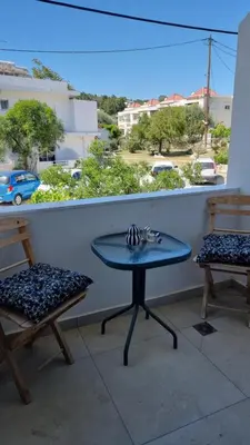 a table and two chairs on a balcony with a view at Sulaj Apartments in Faliraki