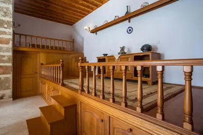 a wooden staircase in a room with wooden floors at Socrates traditional house in Haraki