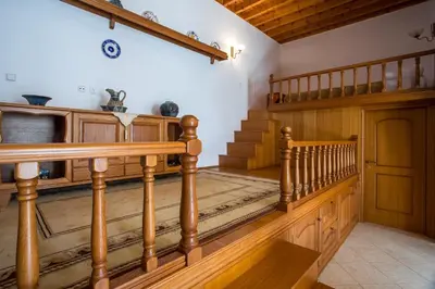a staircase with wooden railings in a room with a stair case at Socrates traditional house in Haraki