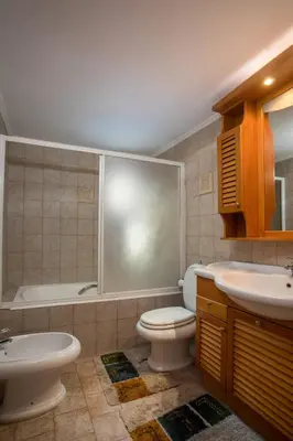 a bathroom with a toilet and a sink and a tub at Socrates traditional house in Haraki