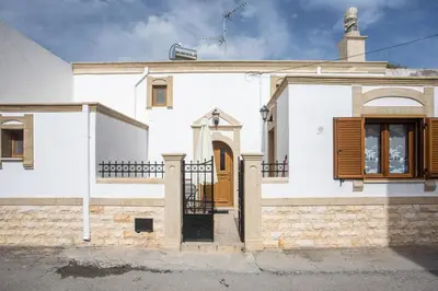 a white house with a brown door andwindows at Socrates traditional house in Haraki