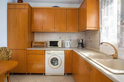 a kitchen with a washing machine and a sink at Socrates traditional house in Haraki