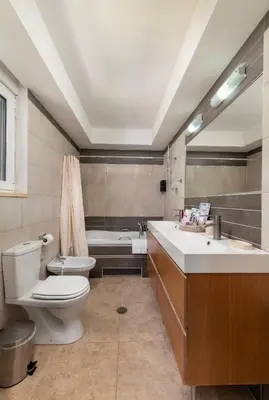 a bathroom with a toilet and a tub and a sink at Lual Palette Rhodos in Afantou