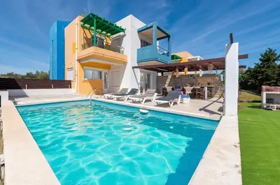 a villa with a swimming pool in front of a house at Lual Palette Rhodos in Afantou