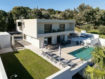 a large white house with a swimming pool at Villa Kennedy in Faliraki