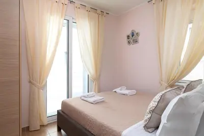 a bedroom with a bed and a large window at Rhodes Garden Retreat in Rhodes Town