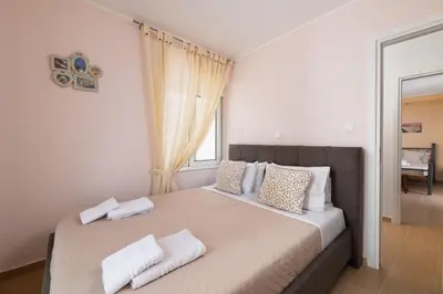 a bedroom with a large bed with white pillows at Rhodes Garden Retreat in Rhodes Town