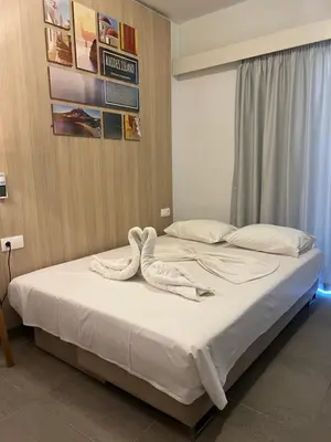a bedroom with a bed with two swans on it at OSIRIS HOTEL APARTMENTS and STUDIOS in Ialyssos
