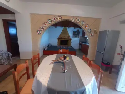 a model of a kitchen with a table with a tableablish at Tassos Holiday home in Archangelos